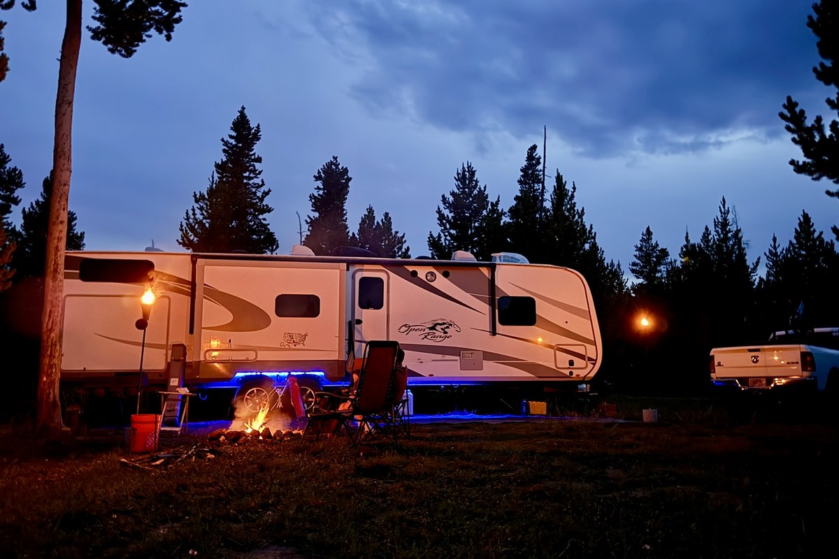 RV campsite at night with a campfire