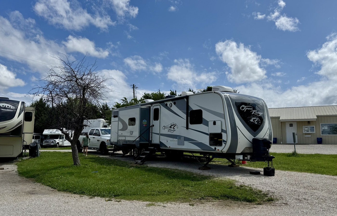 Campfires and Motors RV at a campground under dramatic clouds