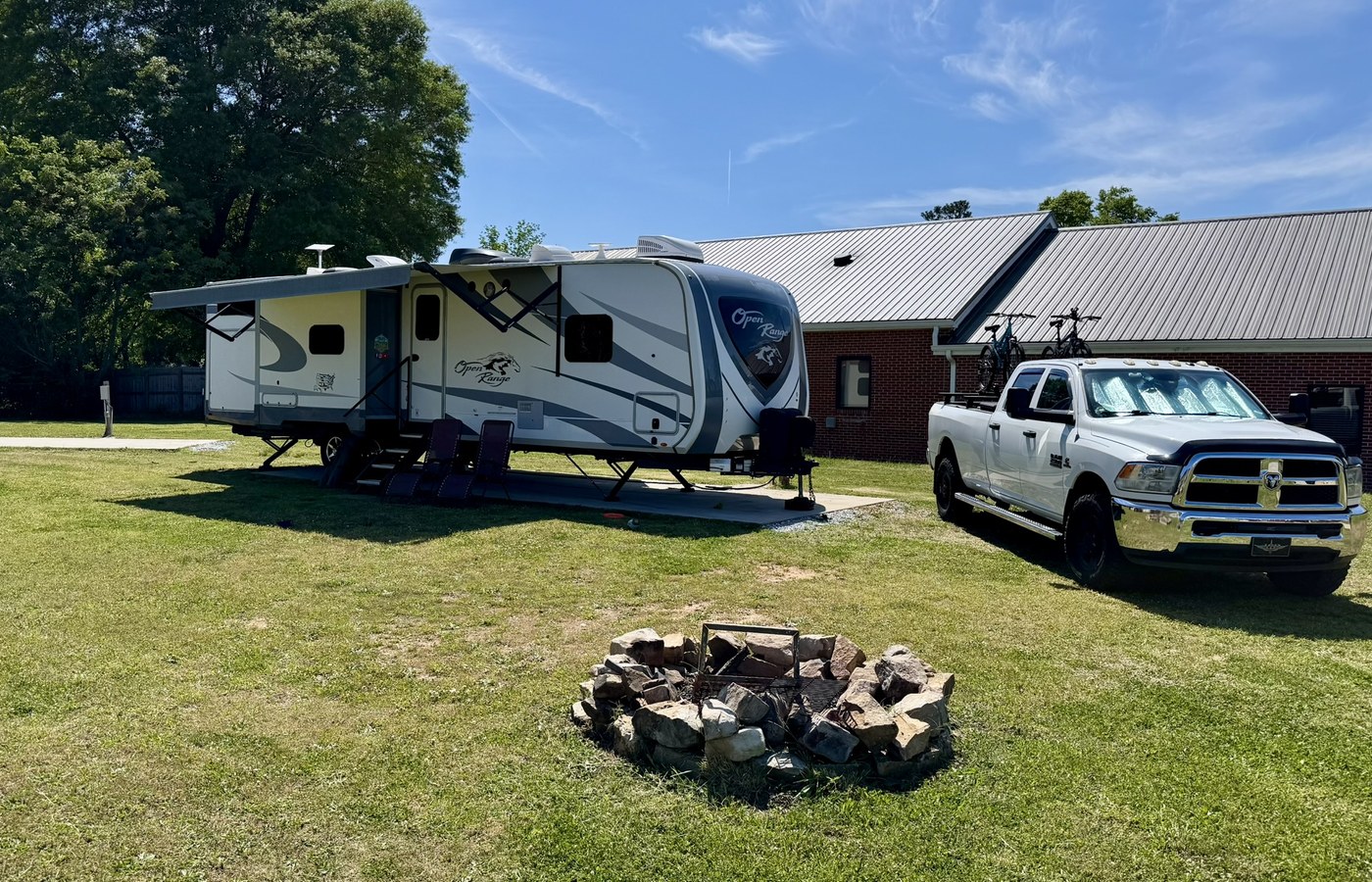 Campfires and Motors RV set up at a grassy campground