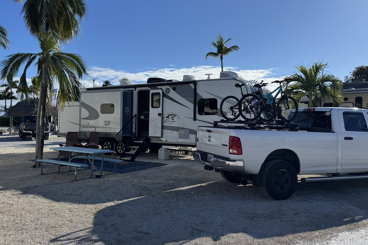 Campfires and Motors truck and travel trailer at a campsite