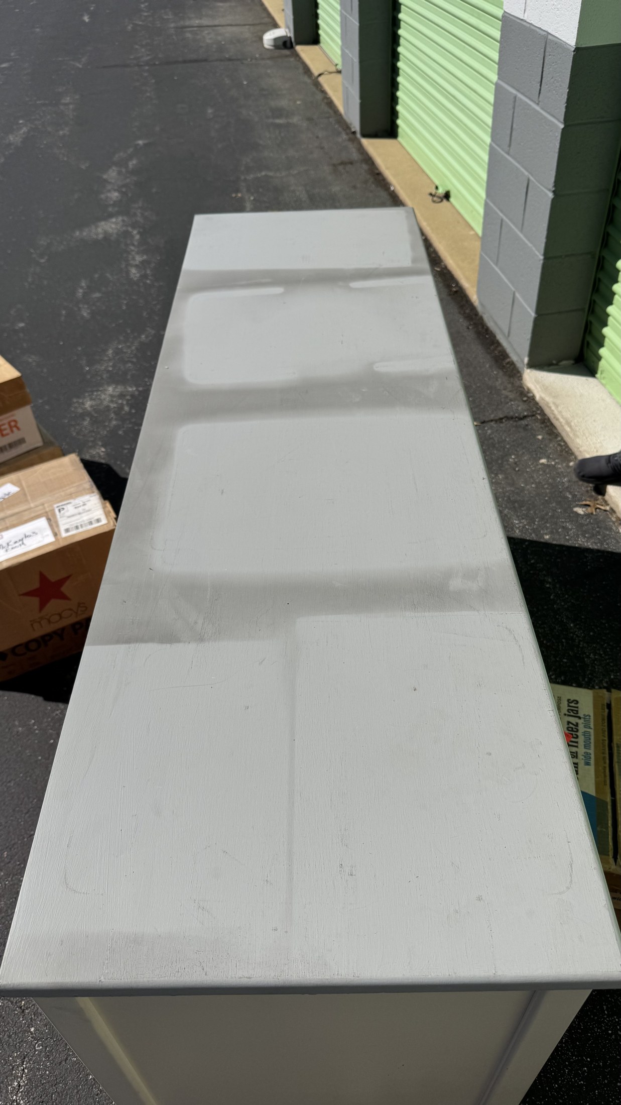 A white dresser top with gray smoke staining and lighter outlines where objects had been resting.